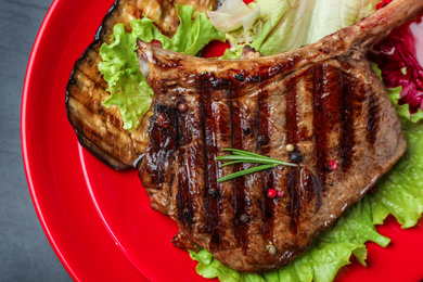 Photo of Top view of delicious grilled beef steak on table