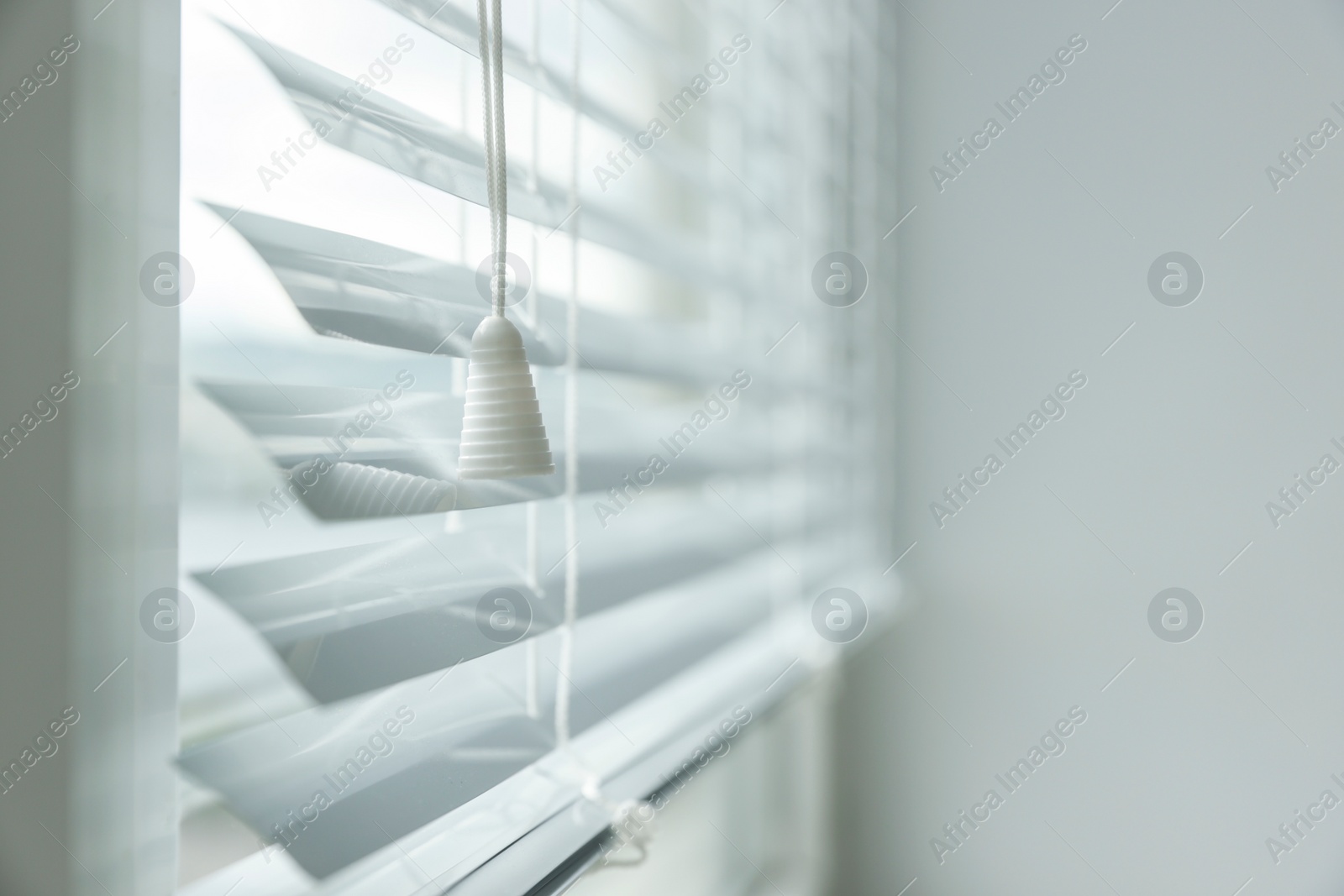 Photo of Stylish window with horizontal blinds indoors, closeup. Space for text