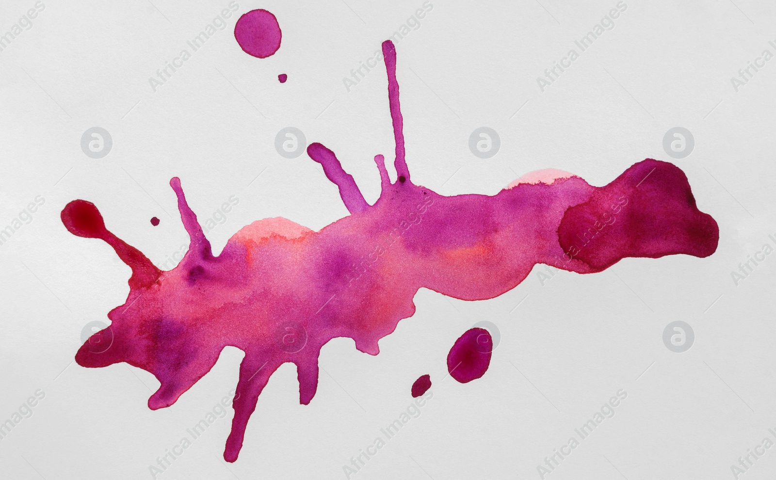 Photo of Blots of colorful watercolor paint on white paper, top view