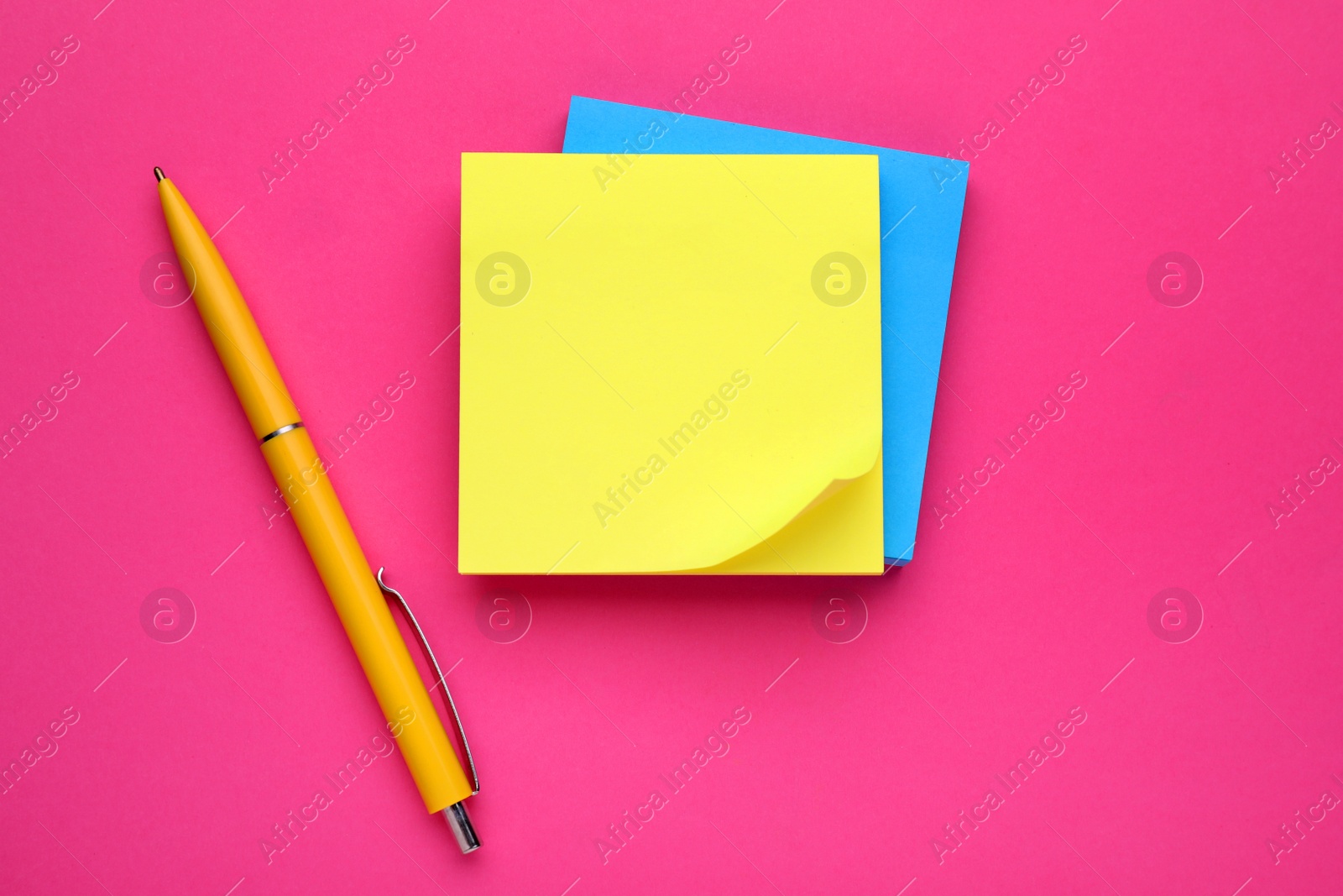 Photo of Colorful empty notes and pen on pink background, flat lay