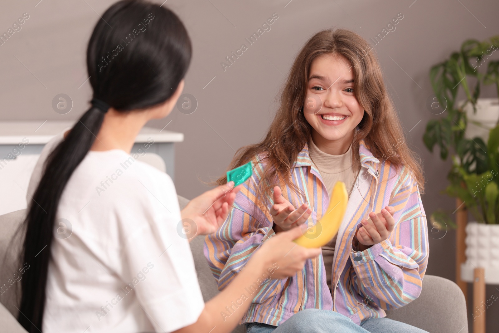 Photo of Mother talking with her teenage daughter about contraception at home. Sex education concept