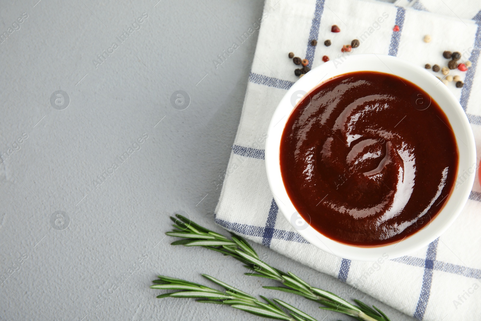 Photo of Flat lay composition with barbecue sauce on grey background. Space for text