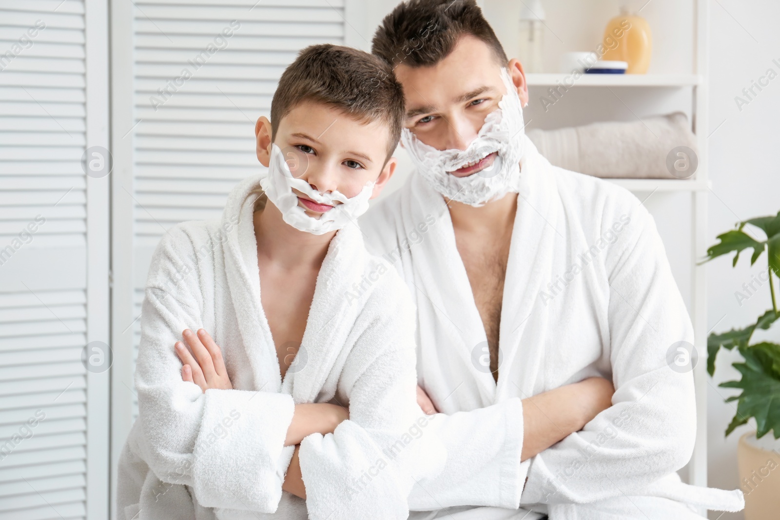 Photo of Dad teaching his son to shave in bathroom