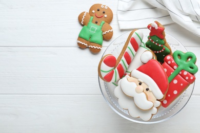 Photo of Decorated Christmas cookies on white wooden table, flat lay. Space for text