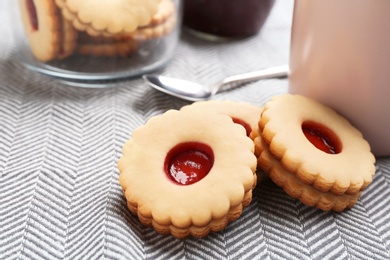 Traditional Christmas Linzer cookies with sweet jam on table