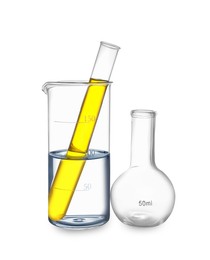 Image of Glass flask, beaker and test tube with yellow liquid isolated on white