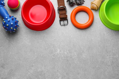 Photo of Flat lay composition with dog collar and different accessories on light grey table, space for text