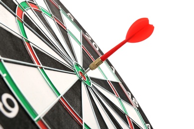 Photo of Dart board with color arrow hitting target, closeup