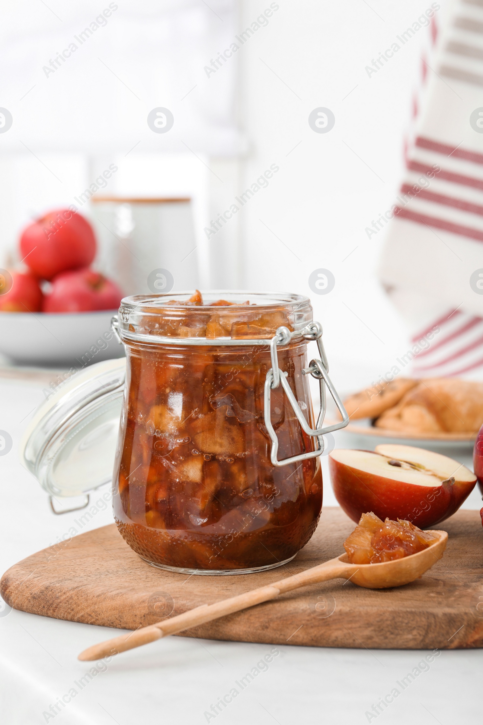 Photo of Delicious apple jam and fresh fruit on white table