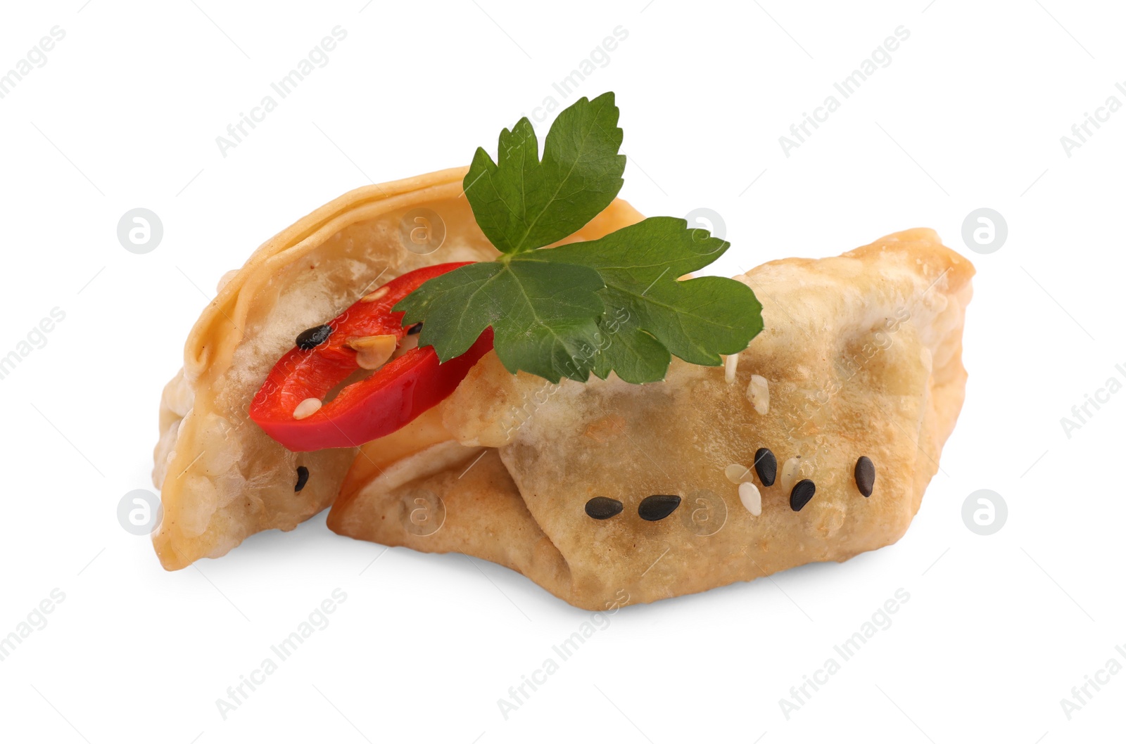 Photo of Delicious gyoza (asian dumplings) with sesame, parsley and pepper isolated on white