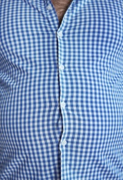 Overweight person in tight clothes, closeup