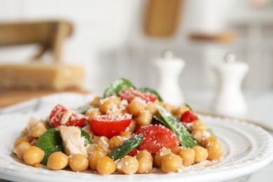 Photo of Plate with delicious fresh chickpea salad on table, closeup