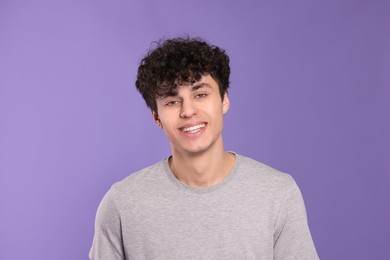 Portrait of handsome young man on violet background