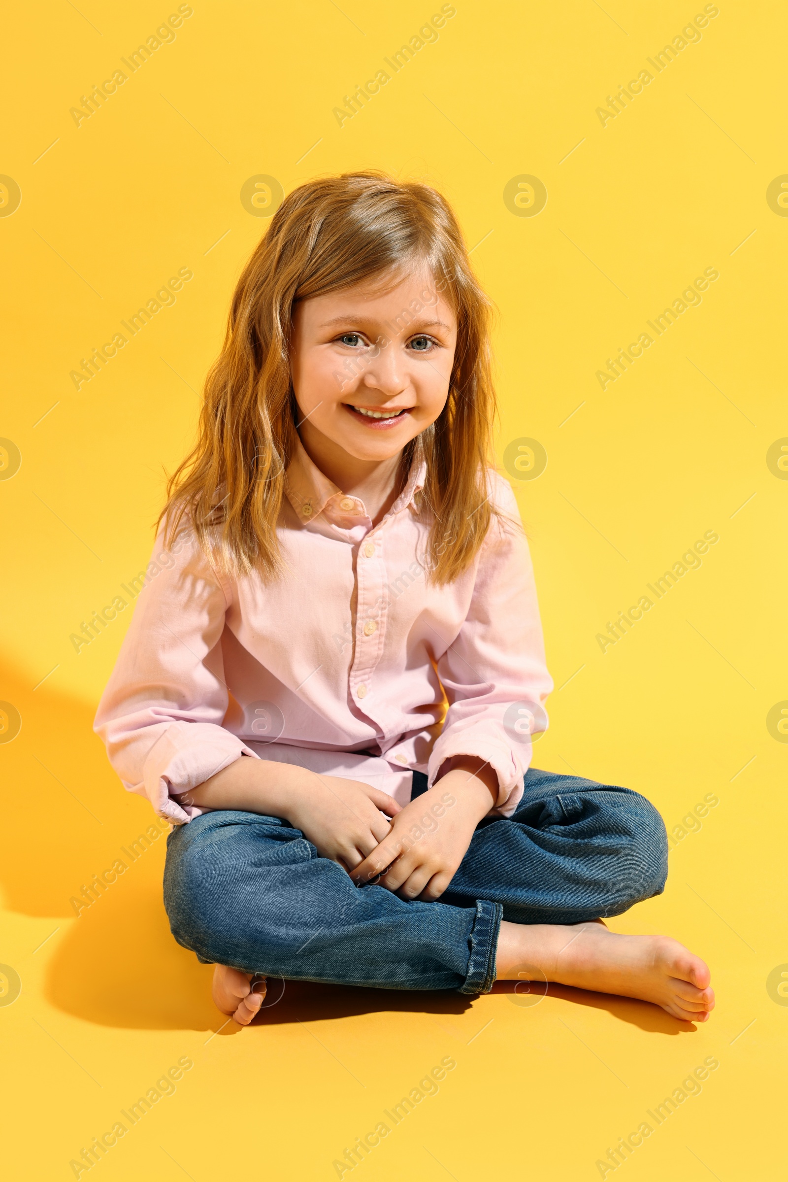 Photo of Fashion concept. Stylish girl posing on yellow background