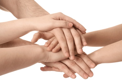 Photo of Young people putting their hands together on white background, closeup