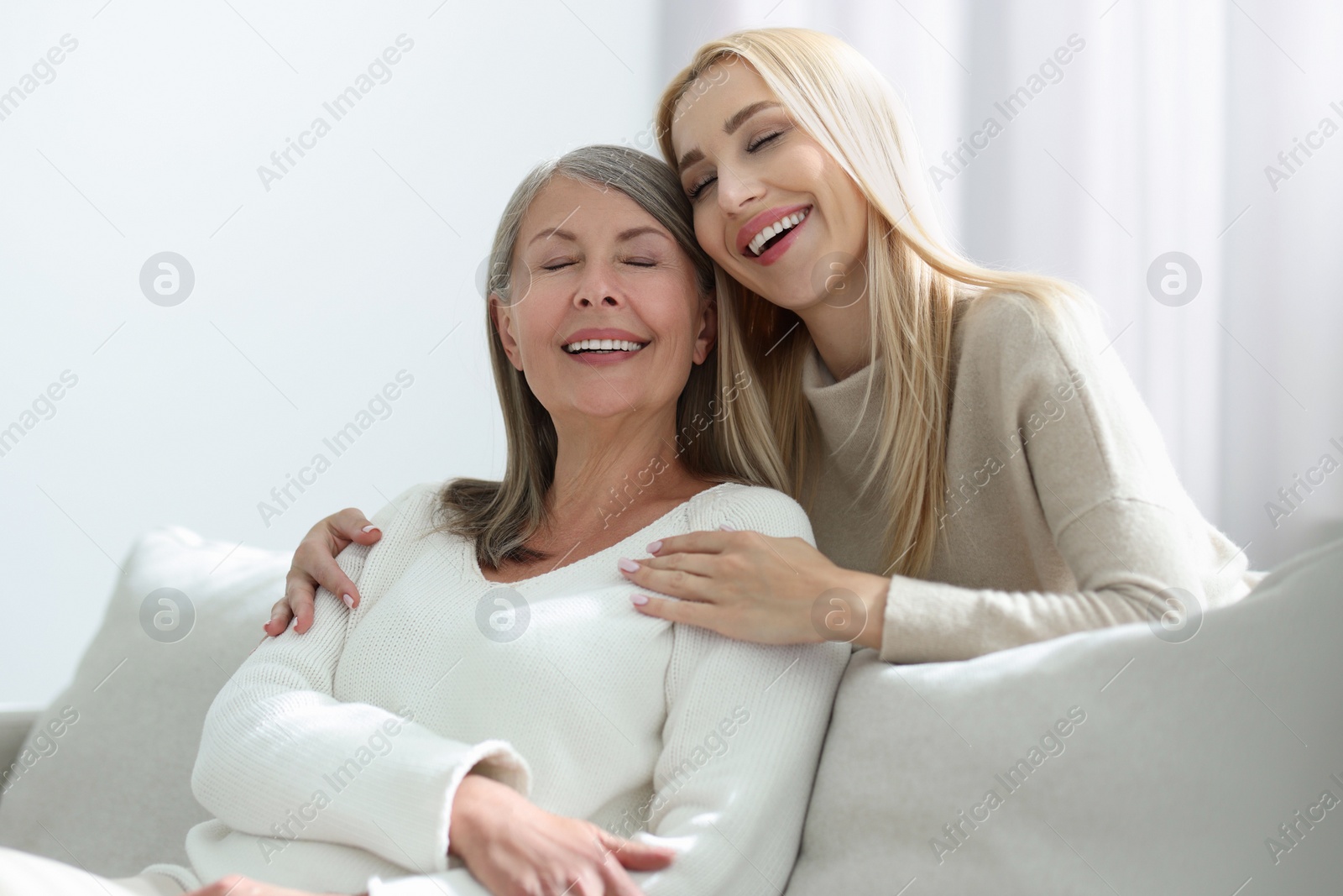 Photo of Family portrait of young woman and her mother at home