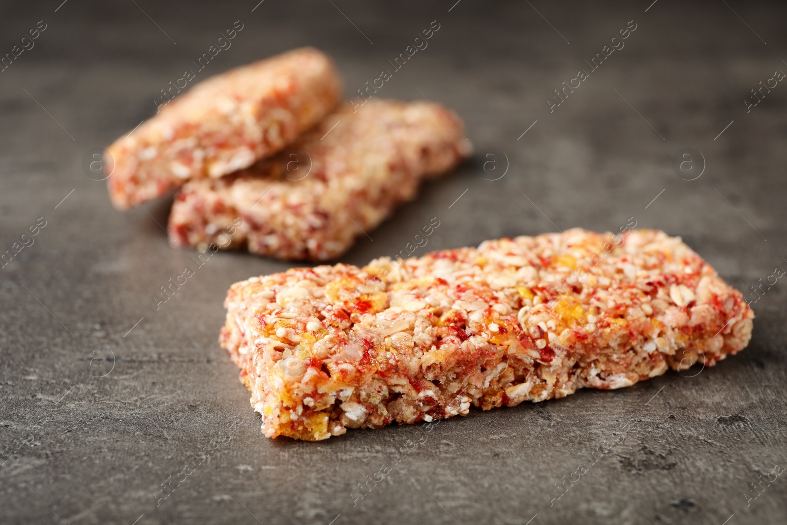 Photo of Tasty protein bars on grey table. Healthy snack