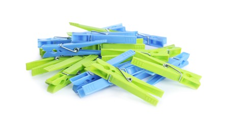 Photo of Many colorful plastic clothespins on white background