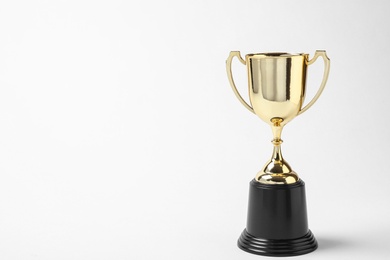 Photo of Shiny golden trophy cup on white background