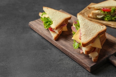 Photo of Tasty toast sandwiches on table. Wheat bread