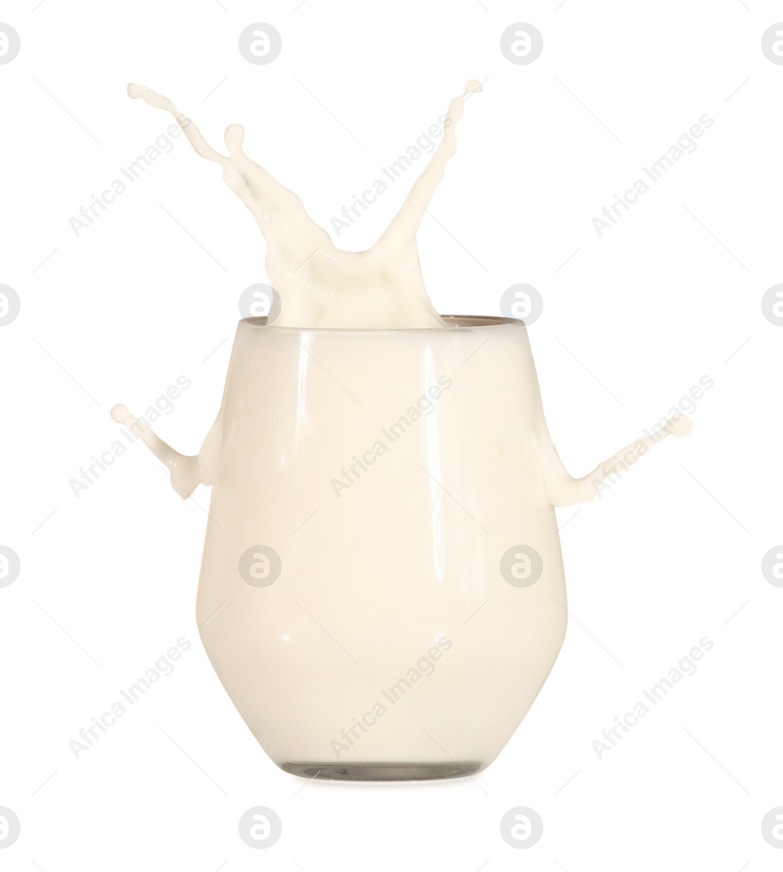 Photo of Milk splashing out of glass on white background