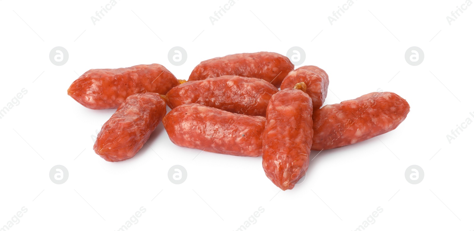 Photo of Many thin dry smoked sausages isolated on white