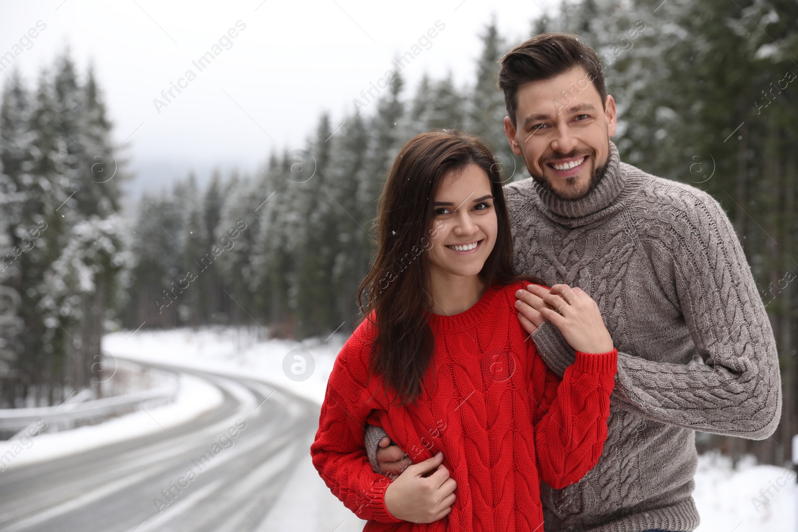 Photo of Cute couple outdoors on snowy day, space for text. Winter vacation