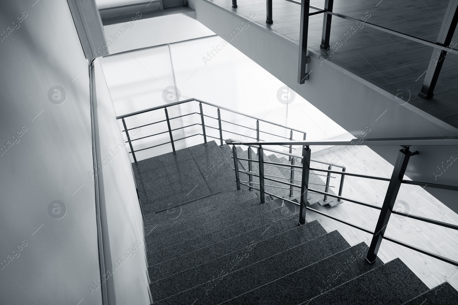 Photo of Stone stairs with metal railing indoors, view through CCTV camera