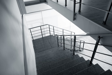 Photo of Stone stairs with metal railing indoors, view through CCTV camera