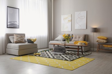 Stylish living room interior with comfortable sofa. Interior design in grey and yellow colors