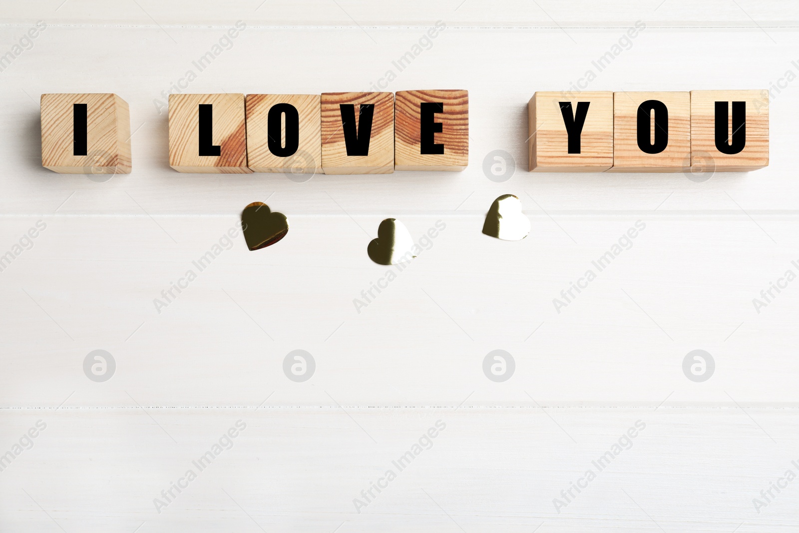 Photo of Phrase I Love You made of cubes on white wooden background, flat lay. Space for text