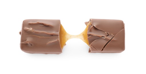 Photo of Pieces of chocolate bar with caramel on white background, top view