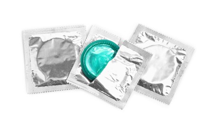 Photo of Condom packages on white background, top view. Safe sex