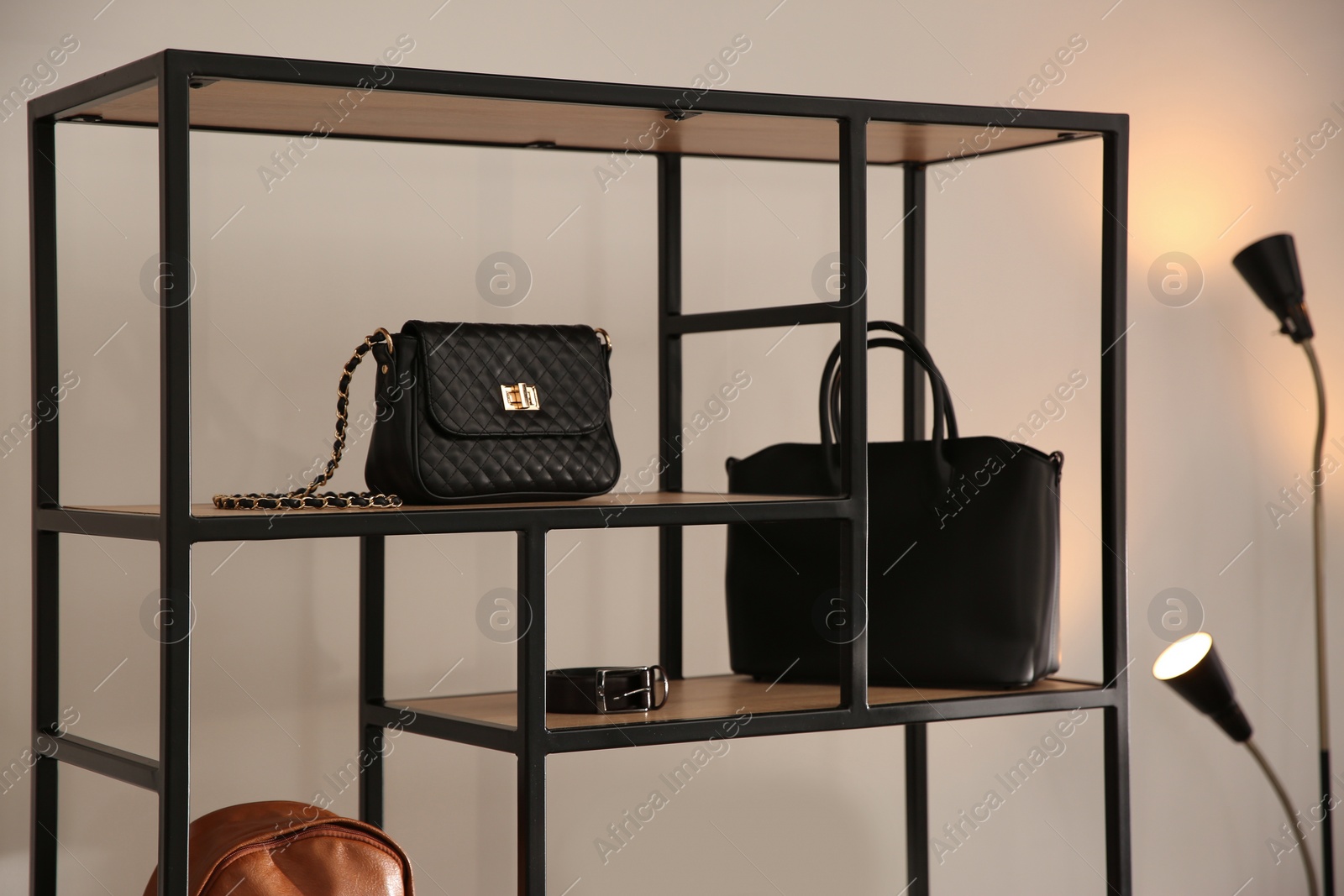 Photo of Collection of stylish women's bags and accessories in luxury boutique