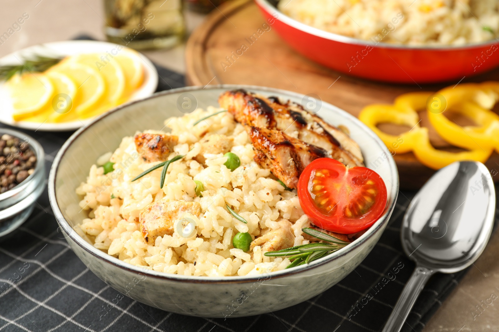 Photo of Delicious chicken risotto with tomato on table, closeup