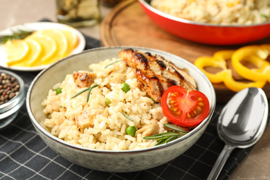 Delicious chicken risotto with tomato on table, closeup