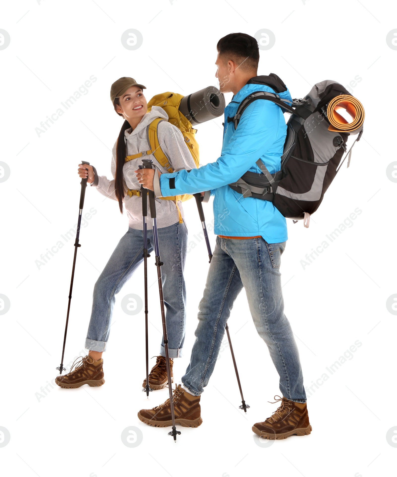 Photo of Couple of hikers with backpacks and trekking poles on white background