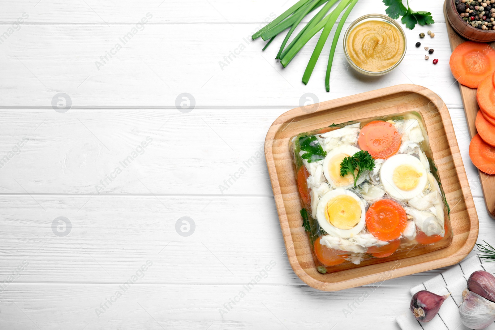 Photo of Delicious fish aspic served on white wooden table, flat lay. Space for text