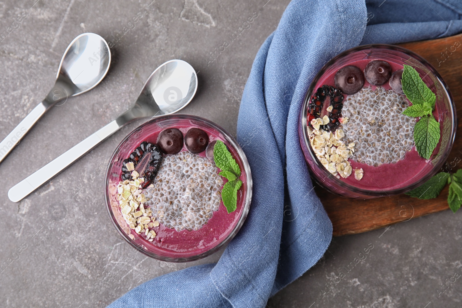 Photo of Flat lay composition with glasses of tasty acai smoothie on gray table