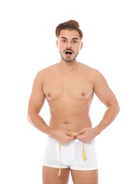 Photo of Fit man measuring his waist on white background. Weight loss