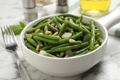 Tasty salad with green beans served on white marble table