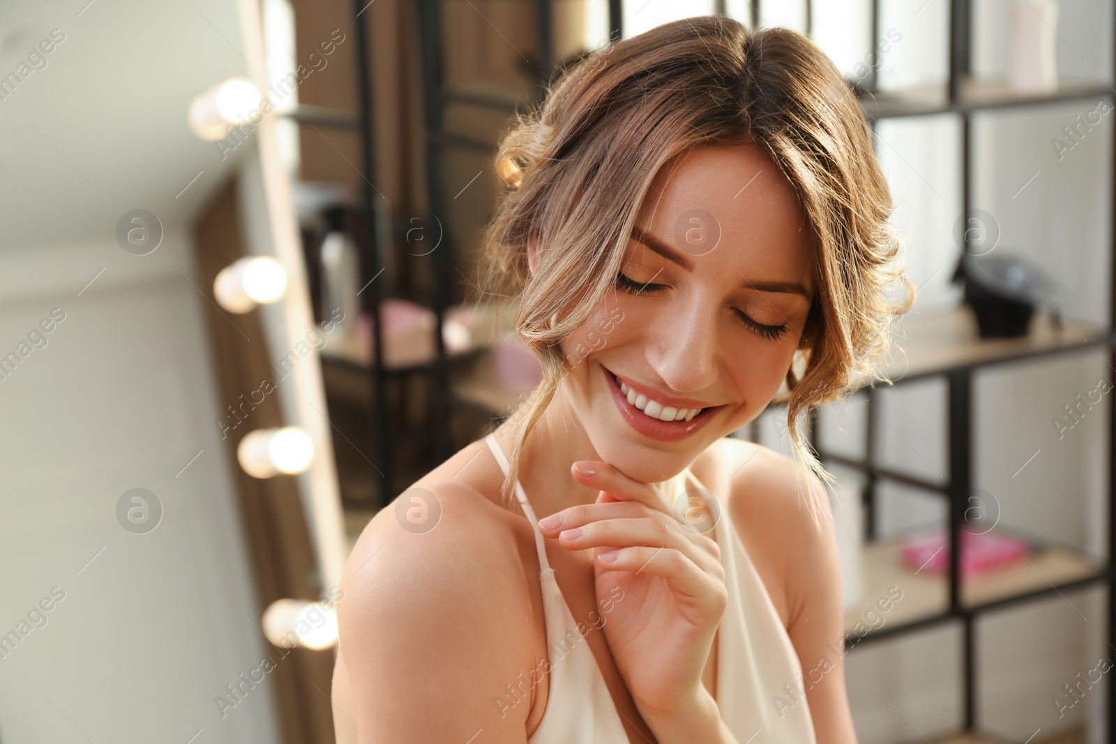 Photo of Happy woman with beautiful hairstyle in salon