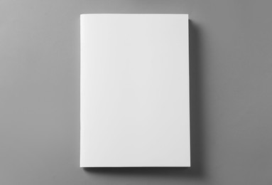 Photo of Brochure with blank cover on light grey background, top view