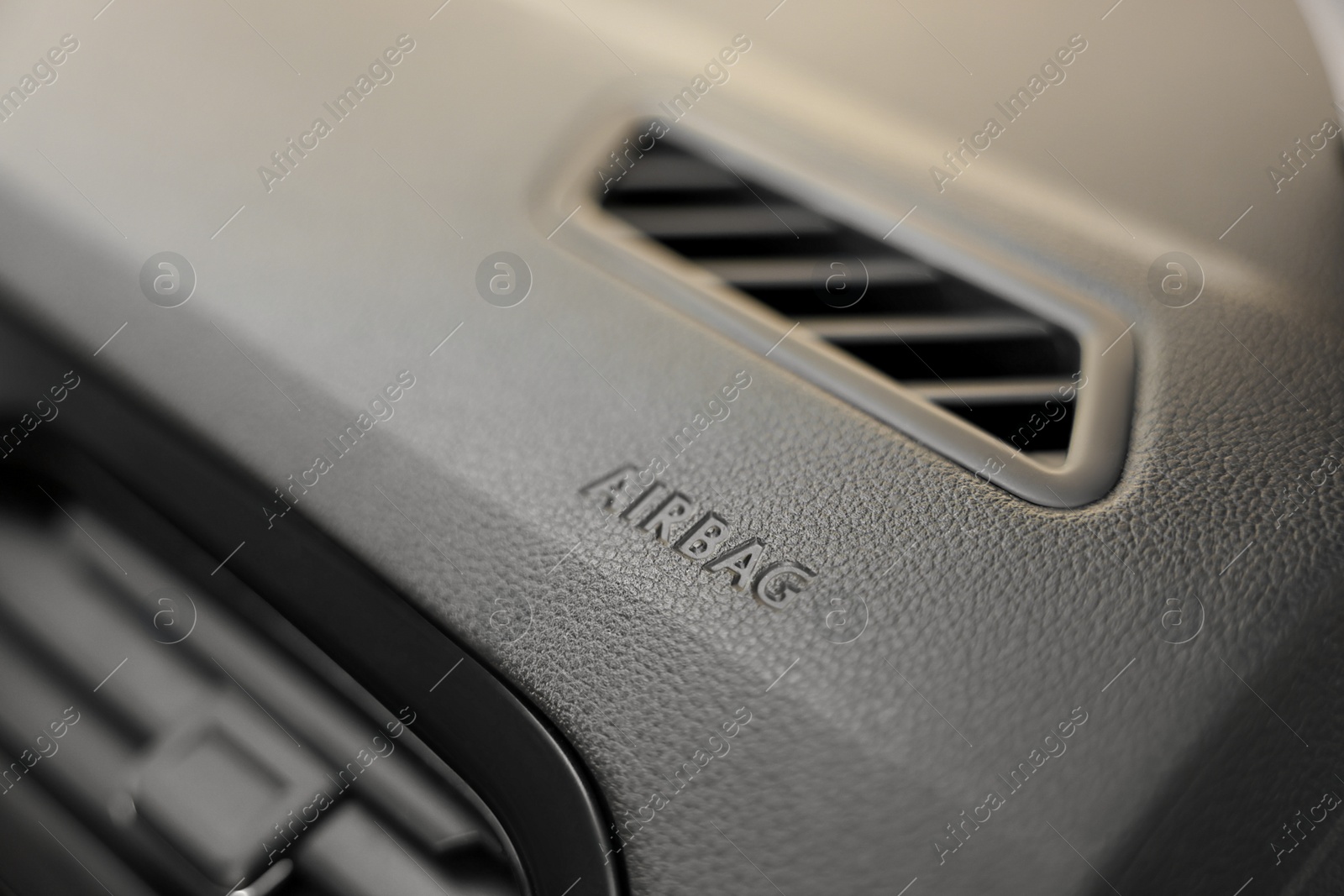 Photo of Safety airbag sign on dashboard in car, closeup