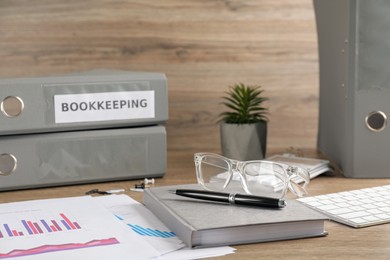 Photo of Bookkeeper's workplace with folders and documents on table