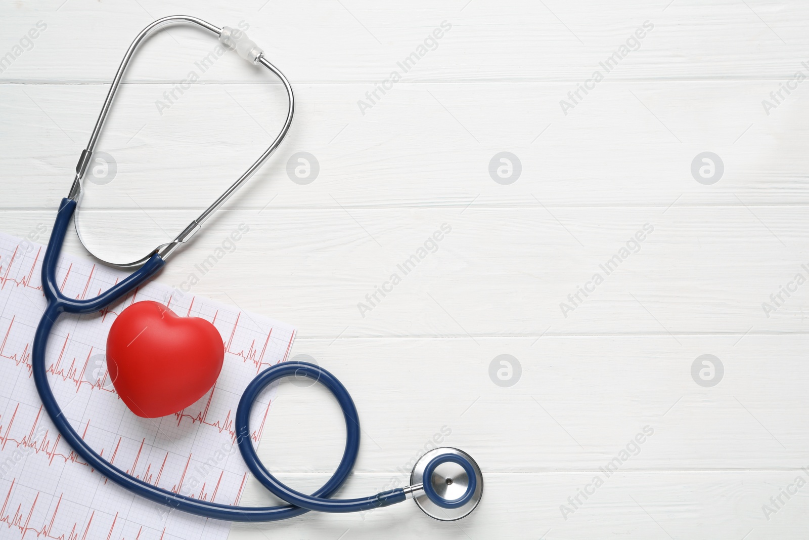 Photo of Stethoscope, cardiogram, red decorative heart and space for text on white wooden background, flat lay. Cardiology concept