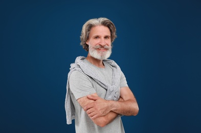 Portrait of handsome mature man on blue background