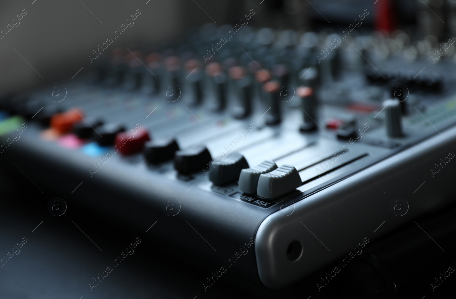 Photo of Modern audio mixing console, closeup. Music equipment