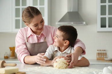 Mother and son cooking together in kitchen