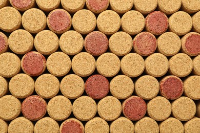 Photo of Many wine bottle corks as background, top view